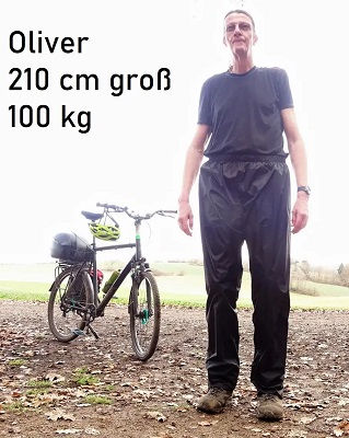 Regenhose Herren Langgröße – Kunde Oliver, 210 cm, 100 kg, mit FlexiFit Überhose und Fahrrad im Hintergrund